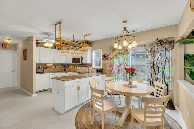 7 Marisa Dr, Middle Island, NY 11953 - kitchen featuring white appliances, white cabinetry, decorative backsplash, a peninsula, and light tile patterned floors