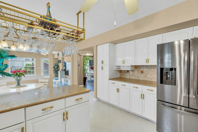 7 Marisa Dr, Middle Island, NY 11953 - kitchen with stainless steel fridge, light tile patterned floors, a ceiling fan, light stone countertops, and backsplash