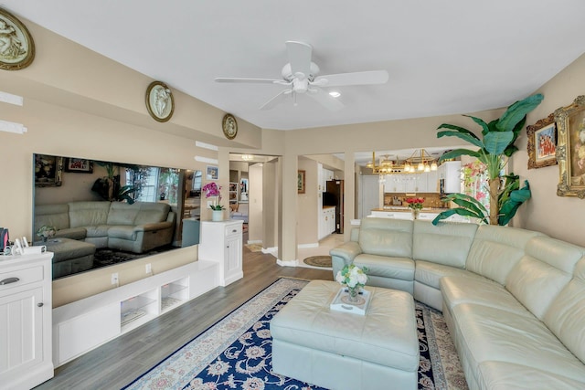 7 Marisa Dr, Middle Island, NY 11953 - living room with a ceiling fan, light wood-style flooring, a chandelier, and baseboards