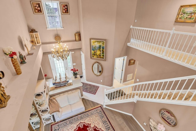 7 Marisa Dr, Middle Island, NY 11953 - entryway featuring a high ceiling, a chandelier, wood finished floors, plenty of natural light, and baseboards