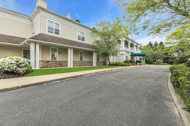 7 Marisa Dr, Middle Island, NY 11953 - view of front of home featuring a chimney, a shingled roof, and stone siding