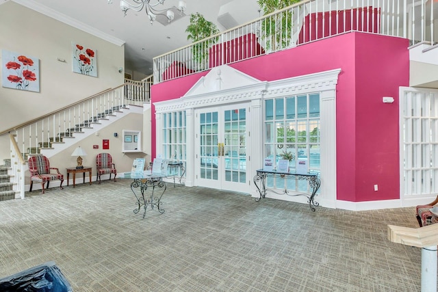 7 Marisa Dr, Middle Island, NY 11953 - carpeted living area with stairs, a high ceiling, crown molding, a chandelier, and french doors