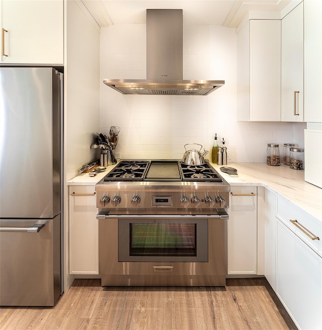 16 Rockledge Ave Unit 5D-2, Ossining, NY 10562 - kitchen with stainless steel appliances, wall chimney range hood, white cabinets, and tasteful backsplash