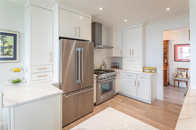 16 Rockledge Ave Unit 5D-2, Ossining, NY 10562 - kitchen featuring premium appliances, wall chimney range hood, light wood-style floors, light stone counters, and recessed lighting