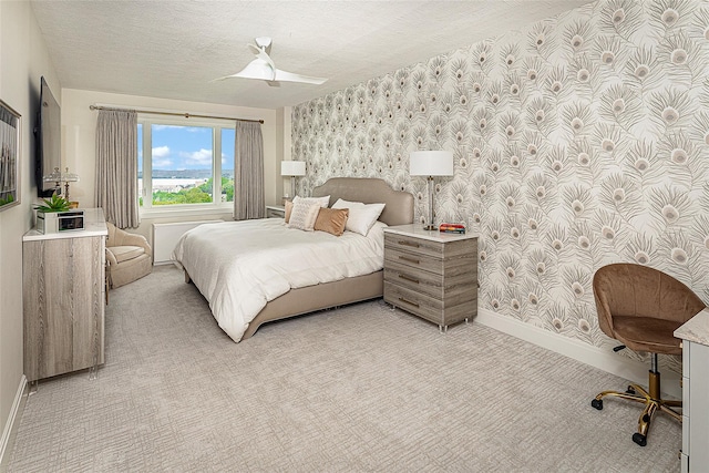 16 Rockledge Ave Unit 5D-2, Ossining, NY 10562 - bedroom with wallpapered walls, baseboards, light colored carpet, and a textured ceiling