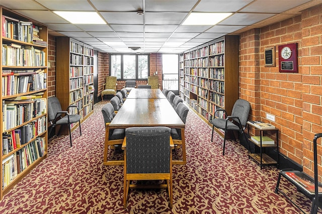 16 Rockledge Ave Unit 5D-2, Ossining, NY 10562 - office area with bookshelves, carpet floors, a drop ceiling, and brick wall
