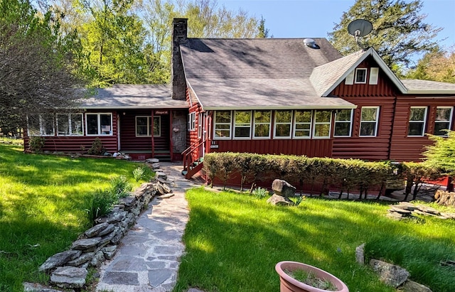 11 W Mongaup Trl, Smallwood, NY 12778 - view of front of home with board and batten siding, a chimney, a front lawn, and a shingled roof