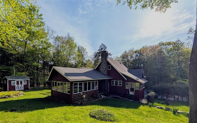 11 W Mongaup Trl, Smallwood, NY 12778 - rear view of property with a yard, a sunroom, a chimney, faux log siding, and a shingled roof