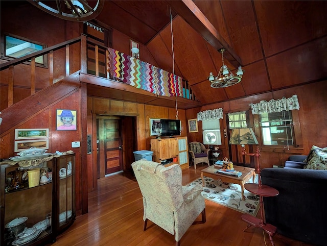 11 W Mongaup Trl, Smallwood, NY 12778 - living room featuring a chandelier, wood finished floors, wood walls, stairs, and high vaulted ceiling