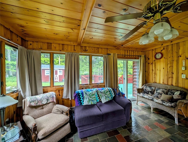 11 W Mongaup Trl, Smallwood, NY 12778 - living room with wood walls, plenty of natural light, wood ceiling with exposed beams, and ceiling fan