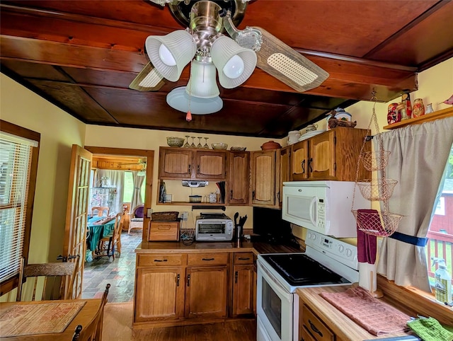 11 W Mongaup Trl, Smallwood, NY 12778 - kitchen with white appliances, plenty of natural light, dark wood-style floors, brown cabinets, and beamed ceiling