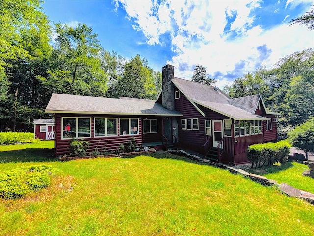 11 W Mongaup Trl, Smallwood, NY 12778 - view of front of property featuring a front yard, a chimney, faux log siding, and a shingled roof