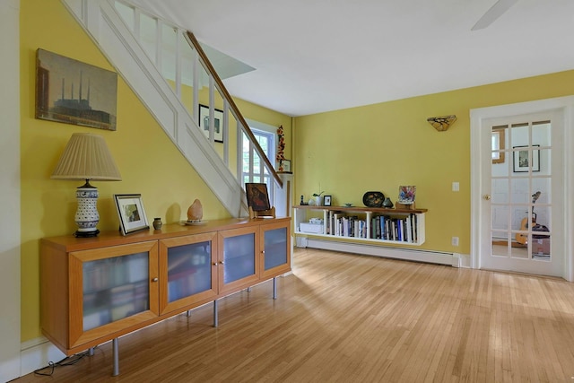 2 Amber Ridge Rd, Chestnut Ridge, NY 10977 - corridor featuring a baseboard radiator, wood finished floors, and stairway