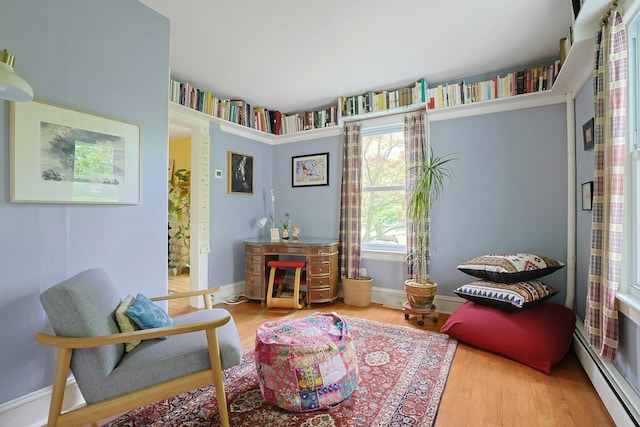 2 Amber Ridge Rd, Chestnut Ridge, NY 10977 - sitting room with plenty of natural light, baseboard heating, wood finished floors, and baseboards
