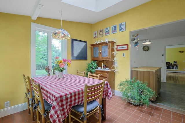 2 Amber Ridge Rd, Chestnut Ridge, NY 10977 - dining area featuring a skylight, dark tile patterned flooring, and baseboards