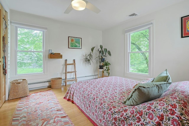 2 Amber Ridge Rd, Chestnut Ridge, NY 10977 - bedroom featuring multiple windows, light wood-style flooring, ceiling fan, and baseboard heating