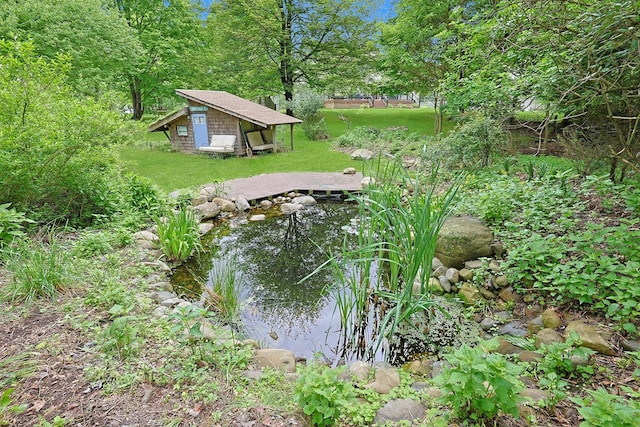 2 Amber Ridge Rd, Chestnut Ridge, NY 10977 - view of green lawn featuring a small pond and an outdoor structure