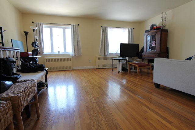 66-36 71st St, Middle Village, NY 11379 - living room featuring radiator heating unit, wood finished floors, and baseboards