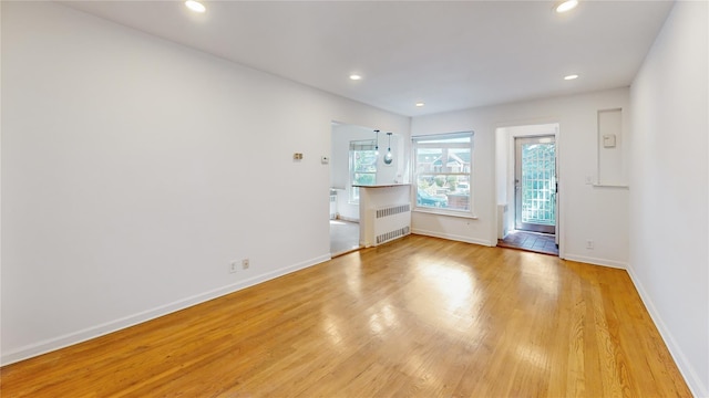 48-17 54th Ave, Maspeth, NY 11378 - unfurnished room featuring radiator, light wood-type flooring, baseboards, and recessed lighting