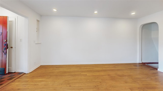 48-17 54th Ave, Maspeth, NY 11378 - unfurnished room with arched walkways, light wood-style floors, recessed lighting, and baseboards