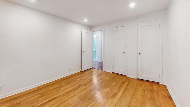 48-17 54th Ave, Maspeth, NY 11378 - unfurnished bedroom with light wood finished floors, baseboards, and recessed lighting