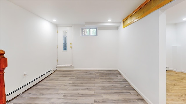 48-17 54th Ave, Maspeth, NY 11378 - basement with a baseboard heating unit, light wood-style floors, recessed lighting, and baseboards