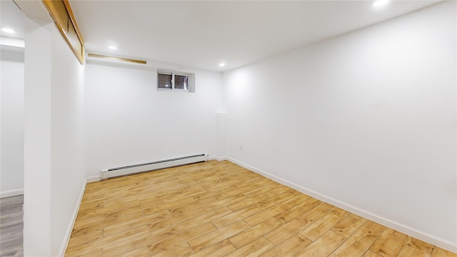 48-17 54th Ave, Maspeth, NY 11378 - finished below grade area featuring baseboard heating, wood finished floors, recessed lighting, and baseboards