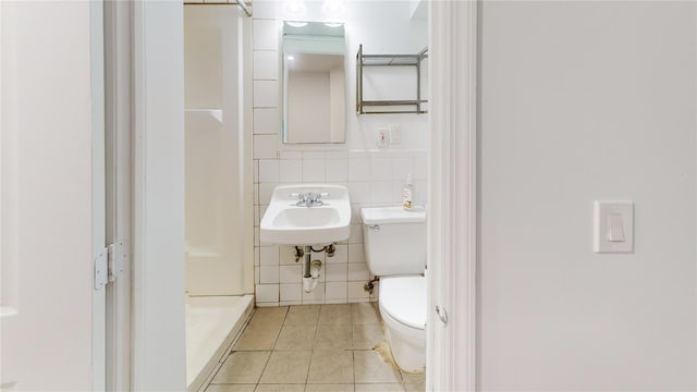 48-17 54th Ave, Maspeth, NY 11378 - bathroom featuring tile patterned flooring, a sink, a stall shower, toilet, and tile walls