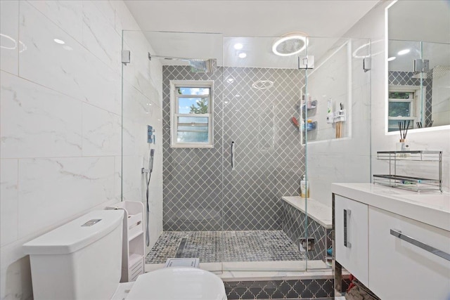 full bath with a shower stall, tile walls, toilet, and vanity