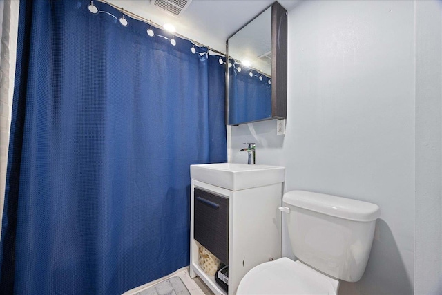 full bath featuring toilet, vanity, and wood finished floors