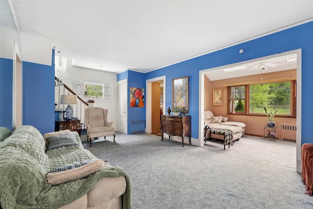 42 Longview Ave, White Plains, NY 10605 - carpeted living area with radiator heating unit, plenty of natural light, and a ceiling fan