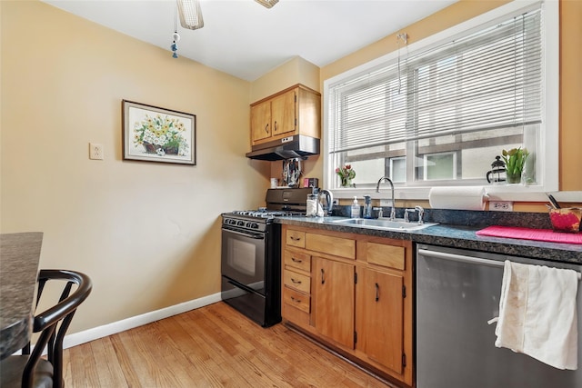 42 Longview Ave, White Plains, NY 10605 - kitchen featuring black gas range oven, dishwasher, under cabinet range hood, a sink, and light wood finished floors