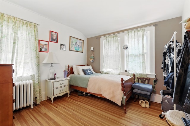 42 Longview Ave, White Plains, NY 10605 - bedroom featuring radiator heating unit, light wood finished floors, and lofted ceiling