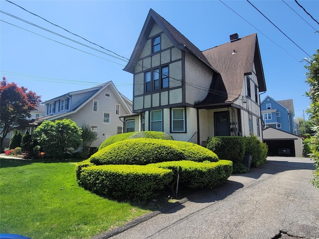 40 Longview Ave, White Plains, NY 10605 - view of front facade featuring stucco siding, a shingled roof, a front lawn, a chimney, and a garage