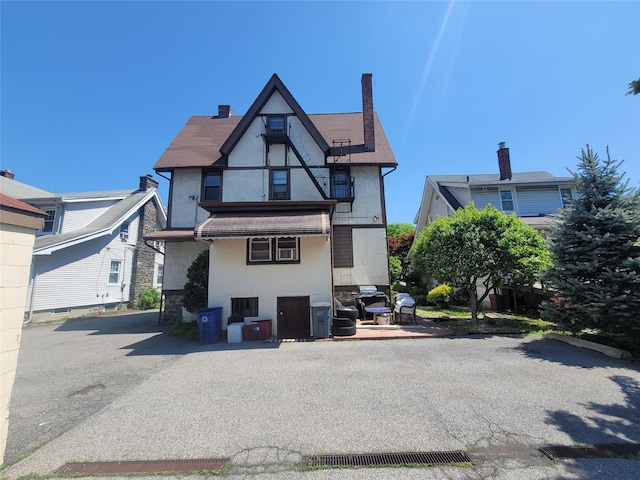 40 Longview Ave, White Plains, NY 10605 - rear view of house with stucco siding, stone siding, and a chimney