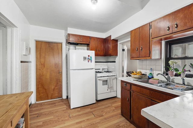 40 Longview Ave, White Plains, NY 10605 - kitchen with white appliances, light countertops, light wood-style flooring, and brown cabinetry