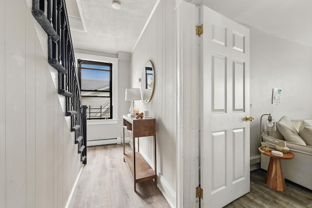 40 Longview Ave, White Plains, NY 10605 - hallway featuring wood finished floors, baseboard heating, stairs, and a textured ceiling