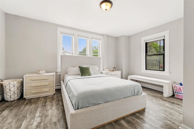 40 Longview Ave, White Plains, NY 10605 - bedroom with wood finished floors, multiple windows, and a baseboard heating unit