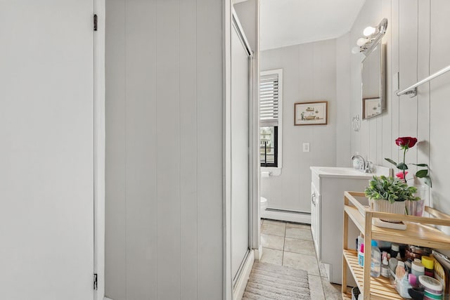 40 Longview Ave, White Plains, NY 10605 - full bathroom with a baseboard radiator, toilet, vanity, a shower with shower door, and tile patterned flooring