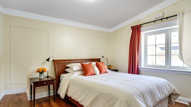 bedroom featuring wood finished floors and baseboards
