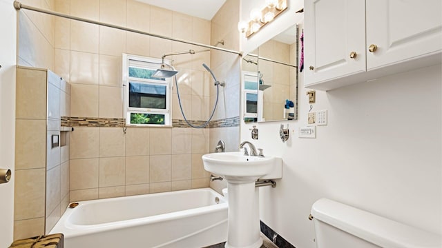 bathroom featuring toilet and bathing tub / shower combination