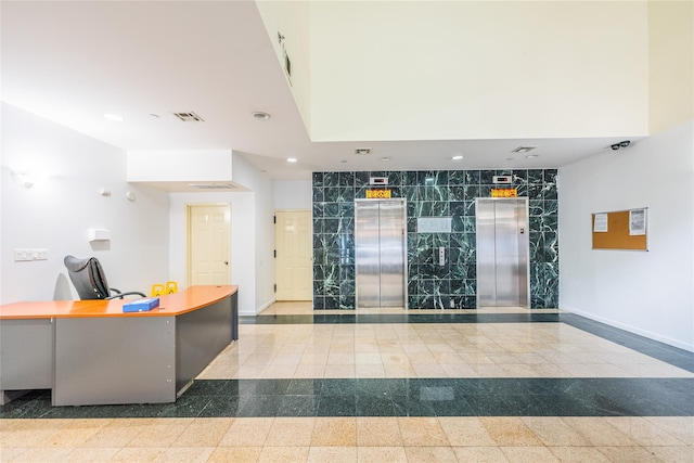 welcome area with recessed lighting and a towering ceiling