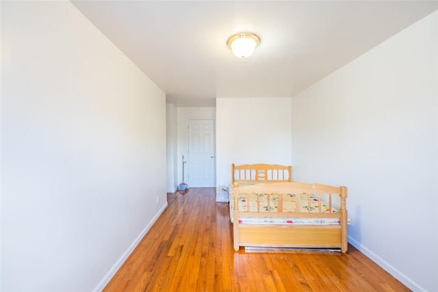 bedroom featuring baseboards and light wood-style flooring