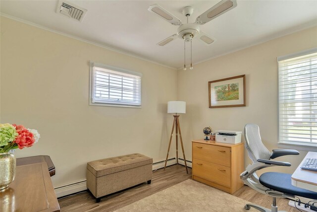 office area with a baseboard radiator, light wood-style floors, ceiling fan, and crown molding