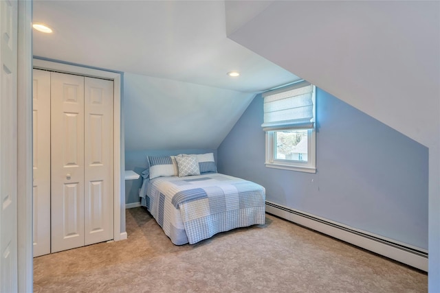 bedroom with a baseboard radiator, carpet, a closet, vaulted ceiling, and recessed lighting