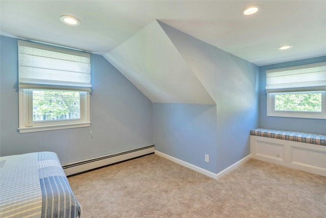 unfurnished bedroom featuring baseboard heating, recessed lighting, vaulted ceiling, light colored carpet, and baseboards