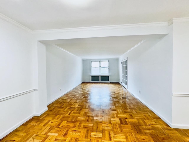 spare room with baseboards and ornamental molding