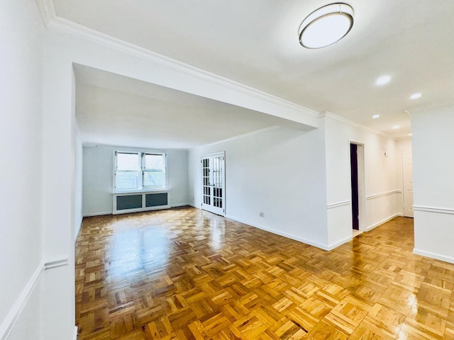empty room featuring crown molding, baseboards, and recessed lighting