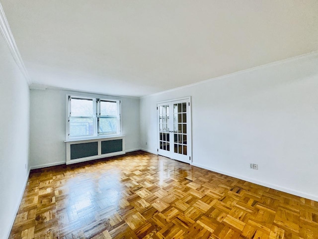 empty room with ornamental molding, baseboards, radiator, and french doors