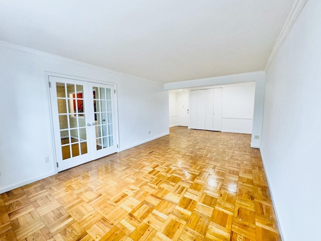empty room with french doors, baseboards, and ornamental molding